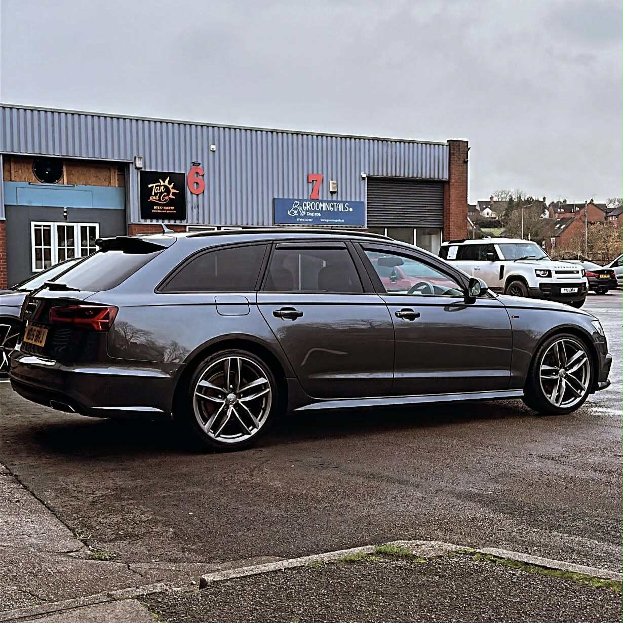 Dark grey Audi A6 Avant with a mirror-gloss finish outside our unit